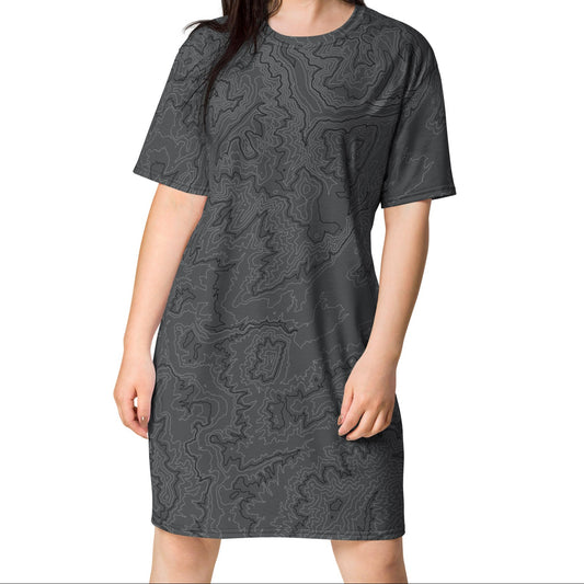 Woman wearing a gray patterned dress on a white background